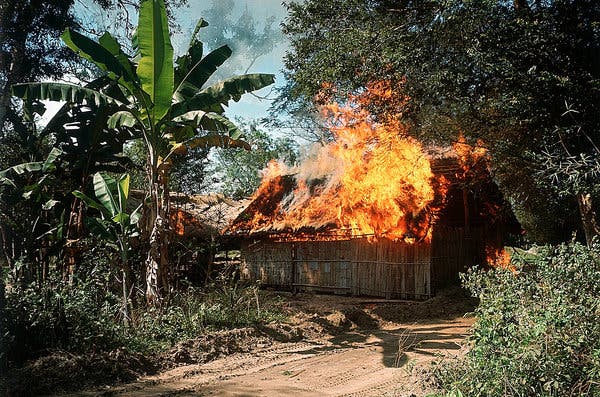 Bamboo huts in flames in Ben Suc, a Viet Cong-controlled village, in January 1967.